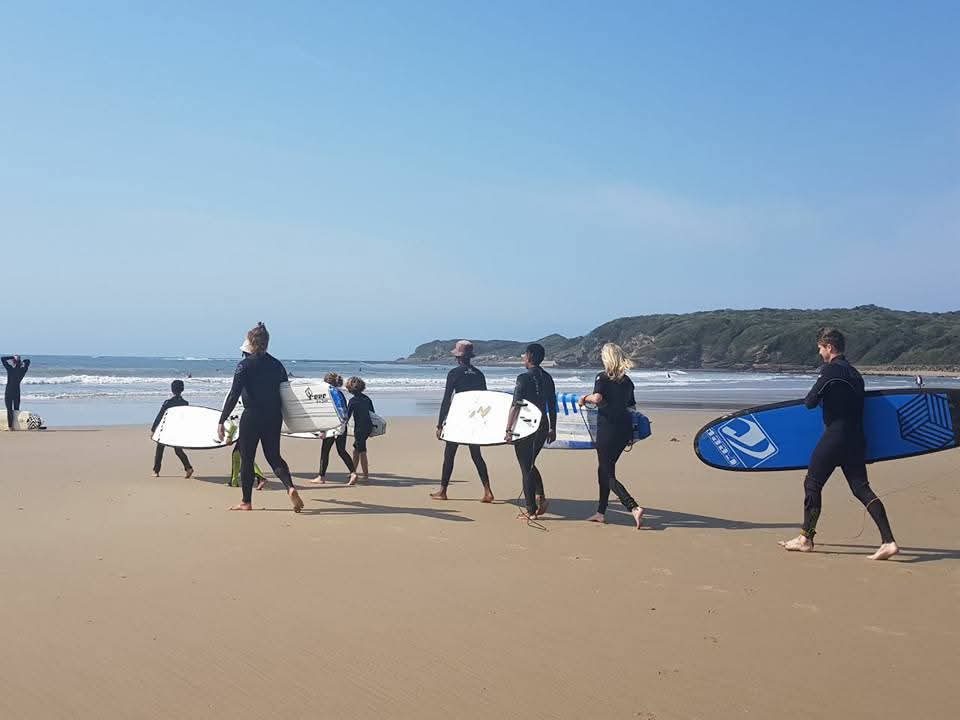 Surf students walking to the water at Nahoon Beach